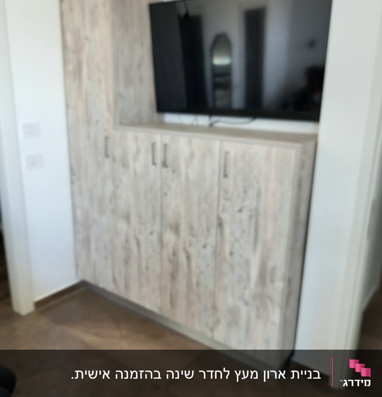 ארון עץ עם טלוויזיה תלויה מעליו